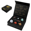 A black gift box containing a natural stone zodiac bracelet and various crystals for Capricorn.