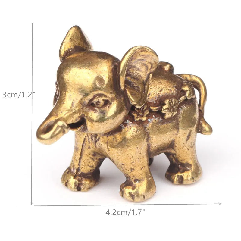 A small antique bronze elephant figurine used as a tea pet or table ornament.