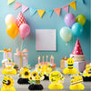 Ein Set aus drei 3D-Bienenwaben- und Sonnenblumen-Papier-Centerpieces mit gelben, rosa und grünen Ballons und Dekorationen.