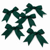 A collection of dark emerald green satin ribbon bows for gifts and DIY crafts.