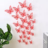 A set of red 3D hollow butterfly wall decals scattered on a white background.