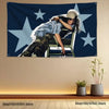 A woman wearing a hat and plaid shirt is depicted on a dark blue tapestry banner featuring large white stars.