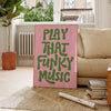 A pink canvas art poster featuring green text that reads PLAY THAT FUNKY MUSIC, displayed indoors.