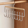A wall-mounted metal coat rack with eight hooks and a storage box hanging on a wooden rod.