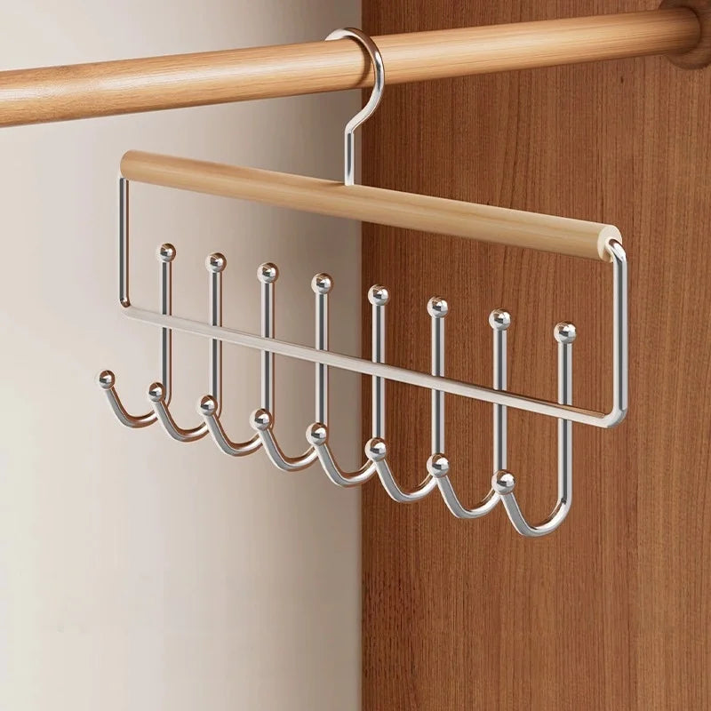 A wall-mounted metal coat rack with eight hooks and a storage box hanging on a wooden rod.