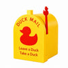 Yellow mailbox shaped like a duck with a red handle and text that reads Leave a Duck Take a Duck