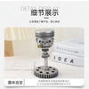 A detailed display of a mechanical punk style piston skull sculpture on a white surface.