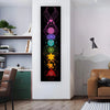 A vertical tapestry featuring a vibrant, geometric design of chakras in pink, purple, blue, and green tones.
