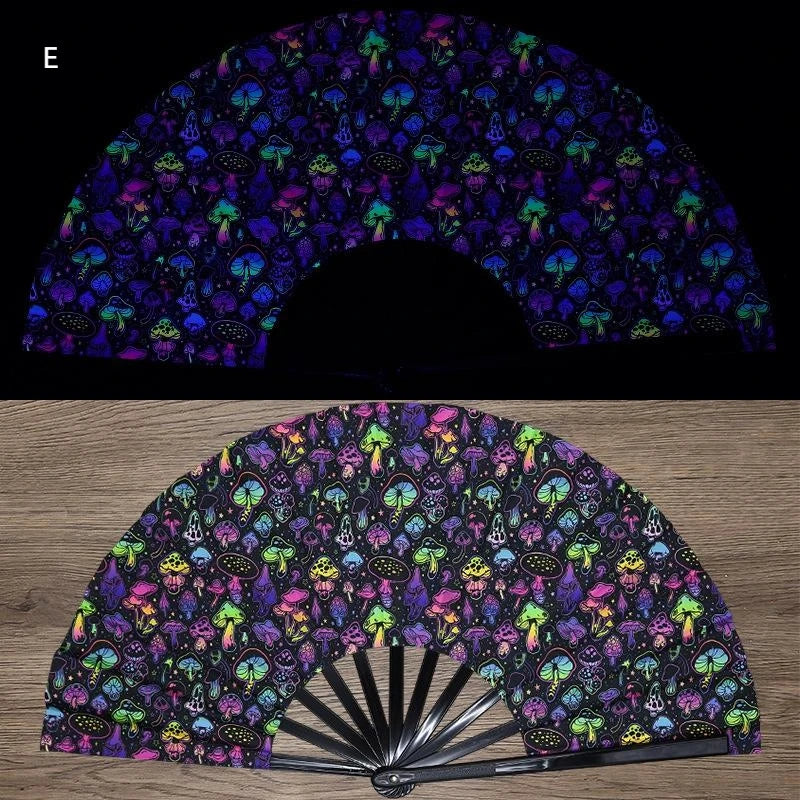 A folding fan with a dark background featuring vibrant UV fluorescent floral and nature patterns.