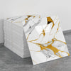 A stack of marble peel-and-stick tile stickers with gold accents displayed on a gray surface.