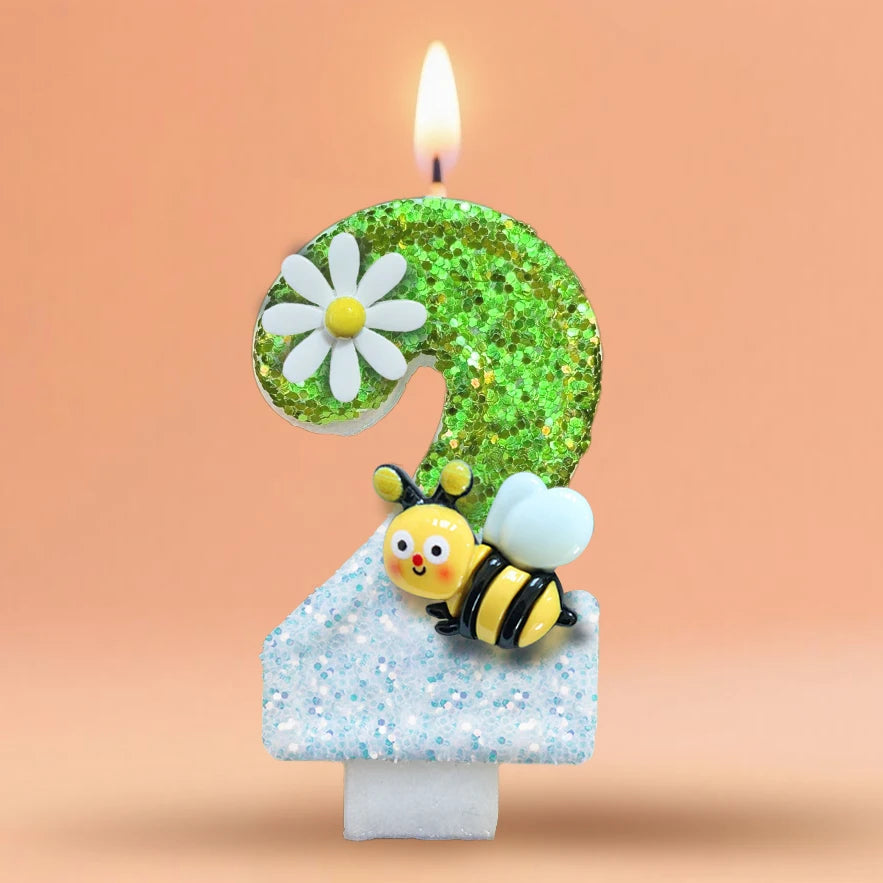 A birthday candle shaped like the number 9, decorated with a white daisy and a yellow bee on a light blue base.