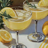 A glass of yellow citrus cocktail garnished with a lemon slice and rosemary on a white surface.