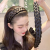 A woman shows off a black braided hair accessory, likely bohemian hair bands for fashion and party.