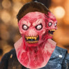 A realistic full-face latex mask resembling a monstrous alien with bright red skin and yellow teeth.
