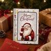 A festive gift card book featuring a Santa Claus illustration surrounded by holiday decorations and wrapped presents.