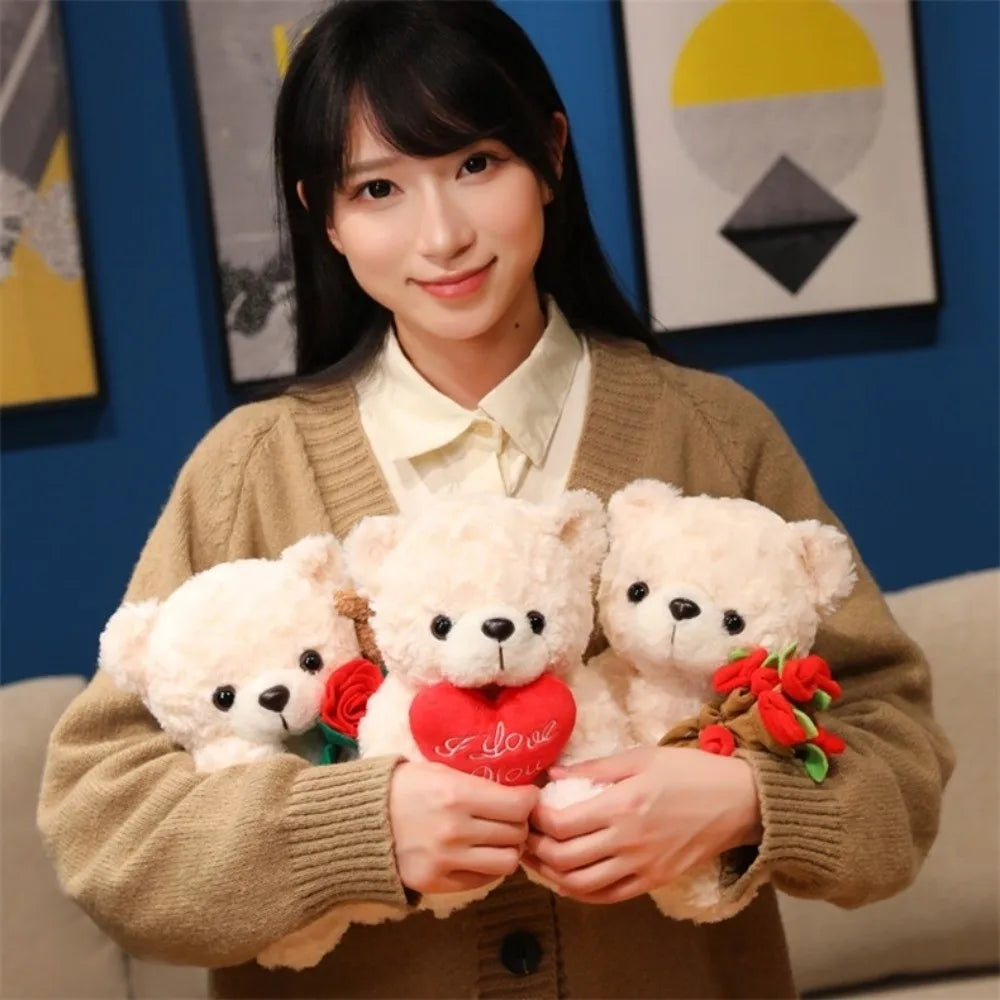 A young woman holds three white teddy bear plush toys with red roses in a warm brown sweater.
