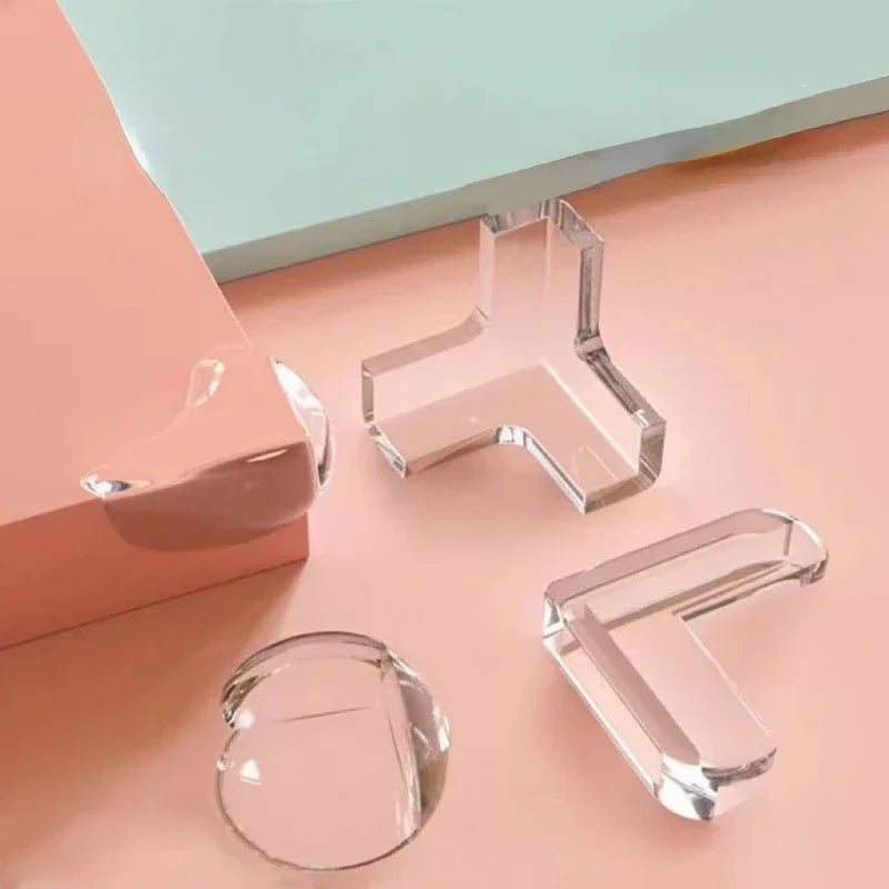 Clear silicone corner protectors for baby safety displayed on a pink surface.