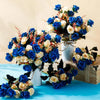 A vibrant bouquet of artificial silk roses in shades of blue and cream arranged on a wooden box.