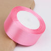 Roll of pink satin ribbon for crafts and gift wrapping