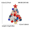 A sparkling rhinestone Christmas tree brooch pin featuring red, blue, and clear stones.