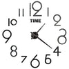A black and silver modern 3D acrylic wall clock face showing the time.