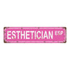 A distressed pink metal tin sign with the word ESTHETICIAN ESP engraved on it.