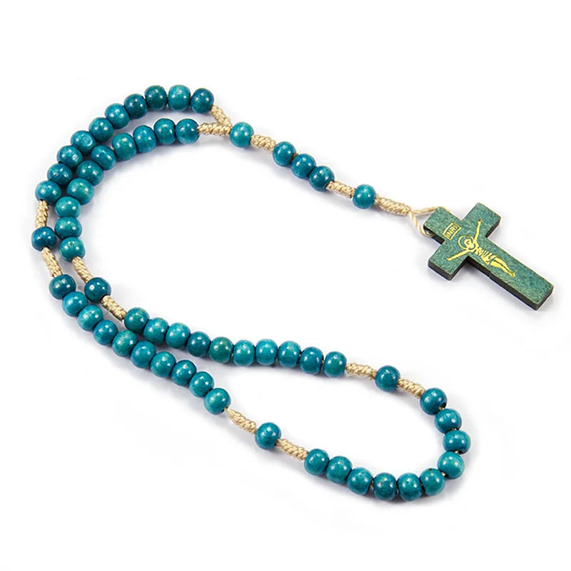 A necklace made of teal blue wooden beads and a small wooden Jesus crucifix.