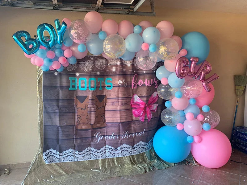 Pink and blue foil letter balloons spelling BOY or GIRL for a gender reveal party display