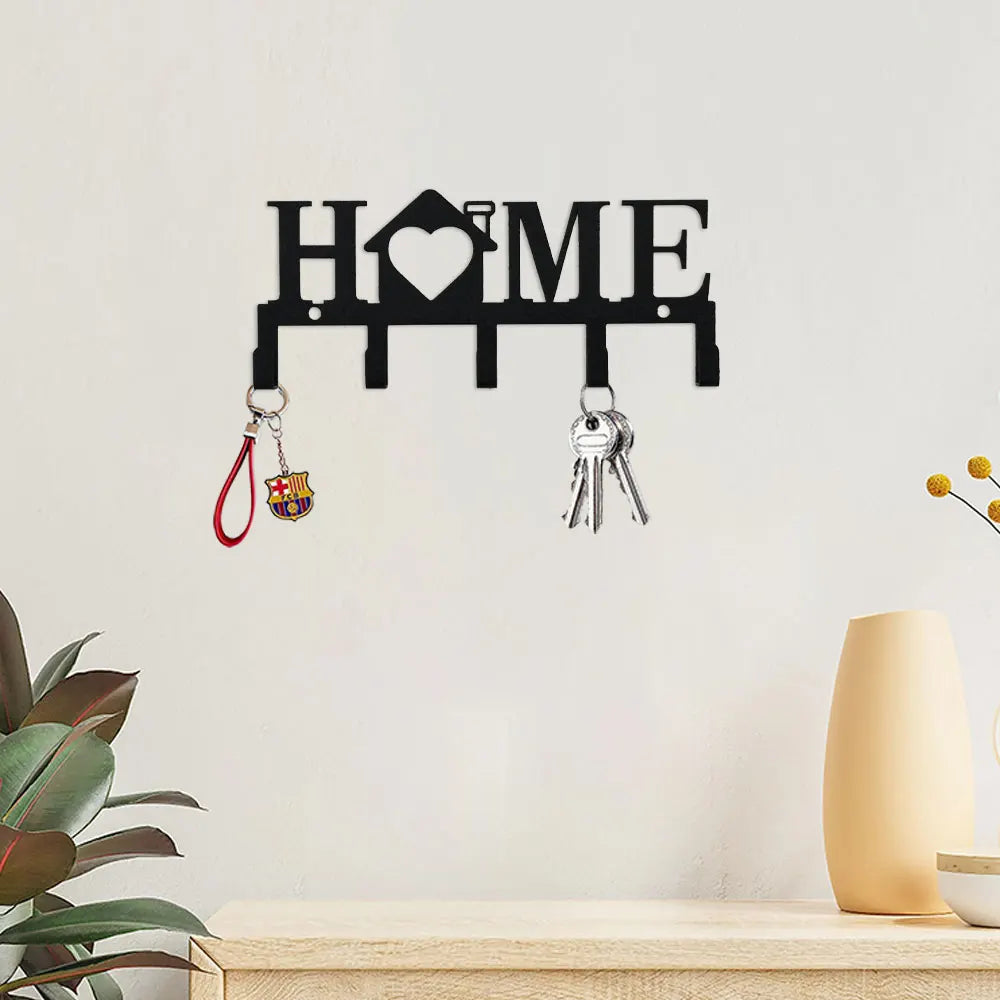 Black wall key holder with a house silhouette and hooks for keys