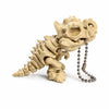 A light beige 3D printed T-Rex skeleton model with articulated joints and a chain hanging from its mouth.
