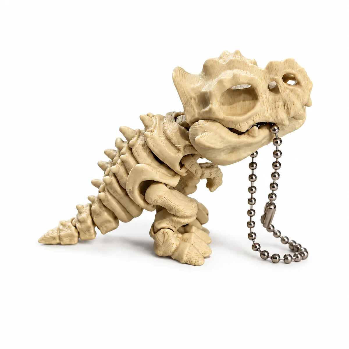A light beige 3D printed T-Rex skeleton model with articulated joints and a chain hanging from its mouth.