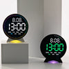 A black LED alarm clock displaying 13:00 and 8.08 with a purple glow on a white surface.