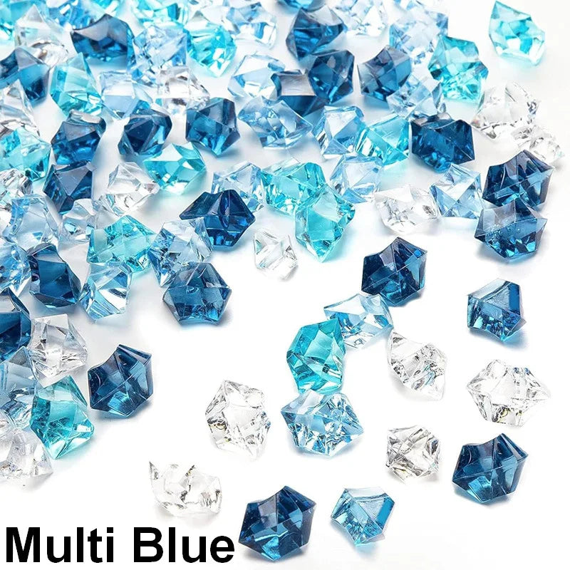 A pile of decorative blue and clear acrylic ice rocks and crystals.