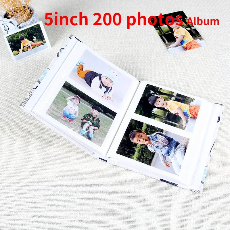 A 5 inch photo album with two pages showing children's photos, including a cartoon character.