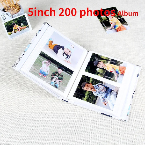 A 5 inch photo album with two pages showing children's photos, including a cartoon character.