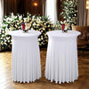 Two white stretch spandex round tablecloths with pleated skirts set up for an elegant event.