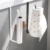 White paper roll holder with a decorative pattern hanging on a kitchen cabinet