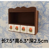 A brown wooden shelf displaying a set of miniature, handcrafted mushroom tableware for dollhouses.