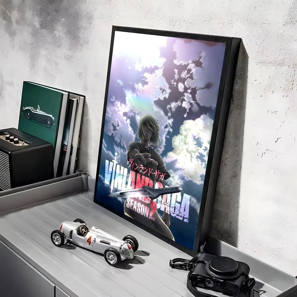 A poster featuring a character from Vinland Saga anime set against a cloudy sky, displayed in a black frame.