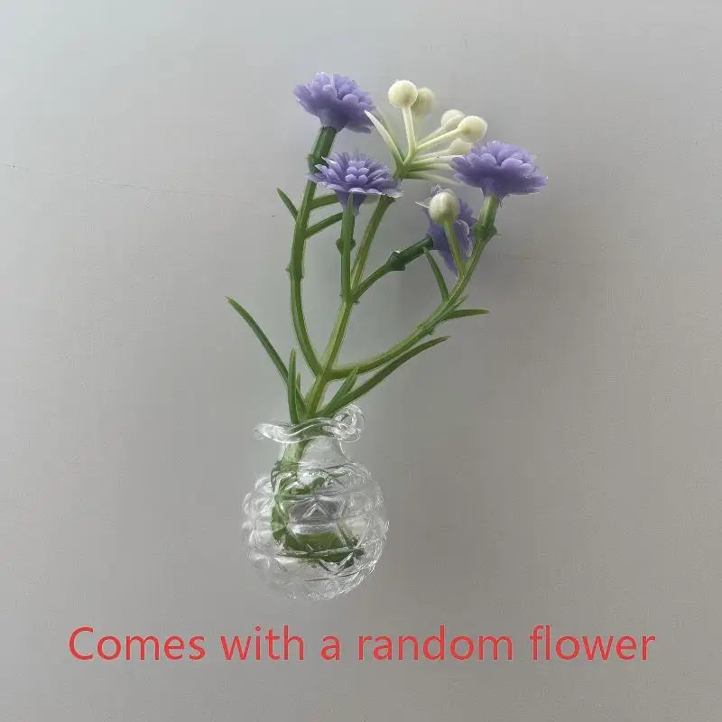 A glass vase holding purple and white flowers, used for fridge decor.