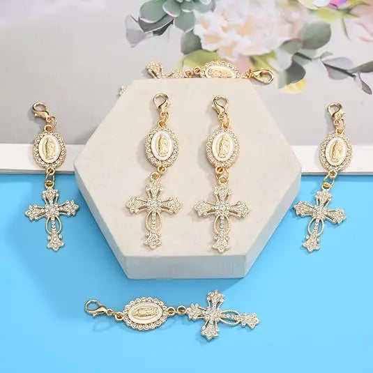 Gold pearl rhinestone cross keychain charms displayed on a white hexagonal stand.