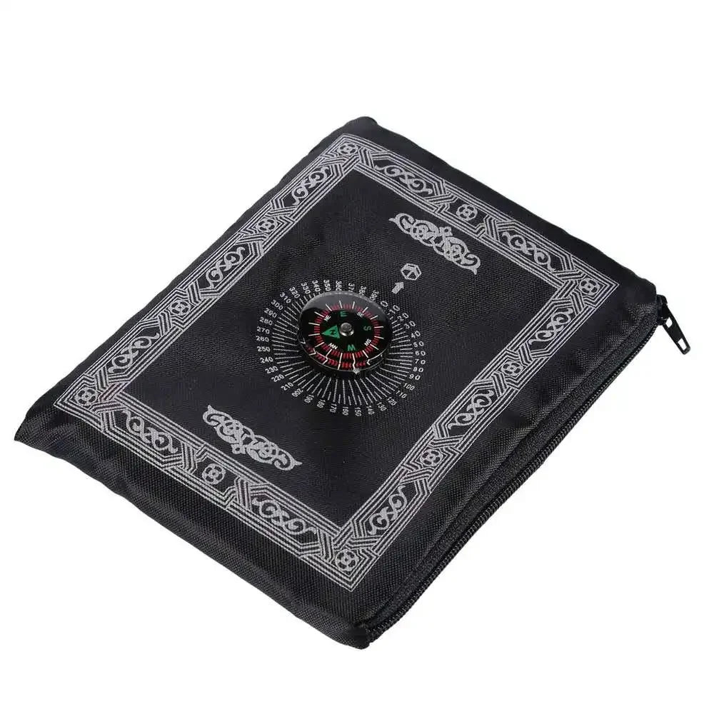 Black portable travel prayer mat with an embedded compass design
