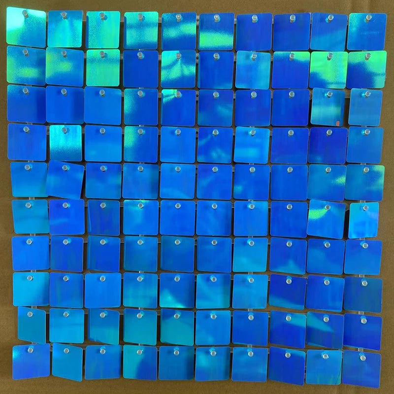 A grid of iridescent blue and green sequin shimmer wall panels used as a sparkling backdrop.