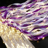 LED glow wands with purple and white ribbons and bells for weddings and parties