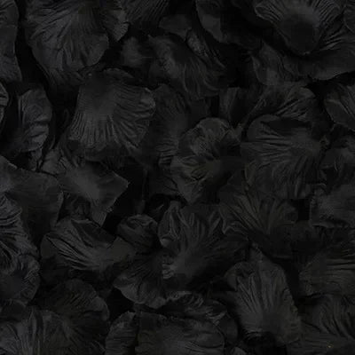 Dark green silk rose petals scattered on a black surface for weddings and special events