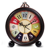 Vintage metal battery alarm clock night light with a round face and numbered dial