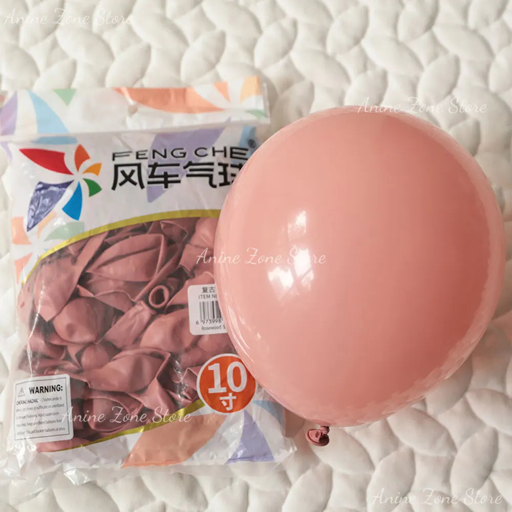 A pink latex balloon is shown next to its packaging for party decorations.