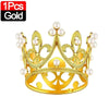 A gold crown cake topper decoration adorned with pearl-like elements.