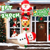 An inflatable decoration featuring a stacked Santa, reindeer, and snowman figure hanging on a brick facade.