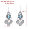 Boucles d'oreilles pendantes en pièce de monnaie turquoise bohème argentées avec des détails de filigrane complexes